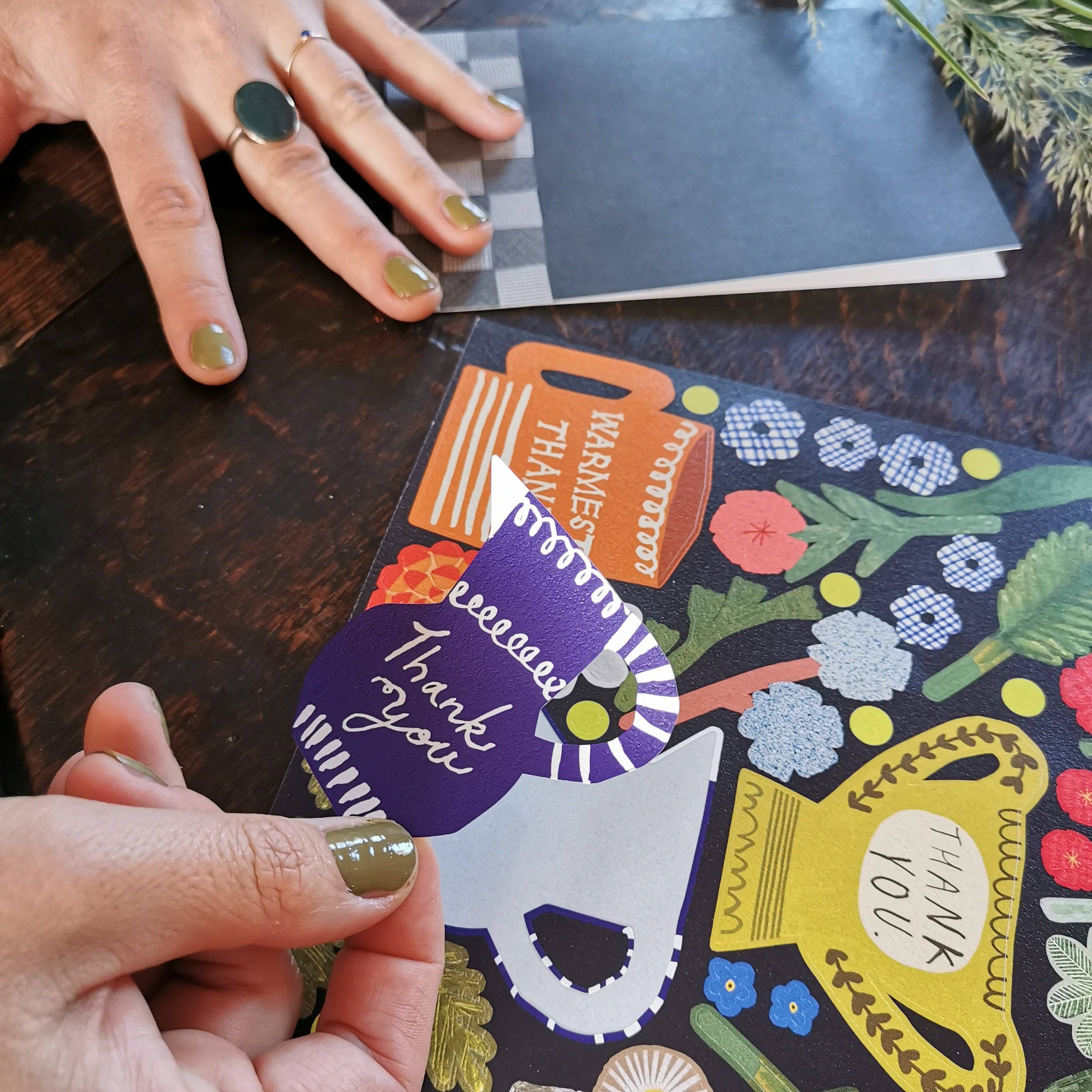 Colorful card with a dog illustration and text on a wooden surface.