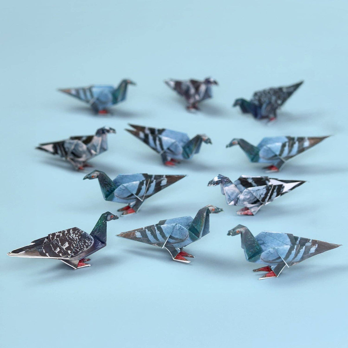 Origami pigeons on a light blue background
