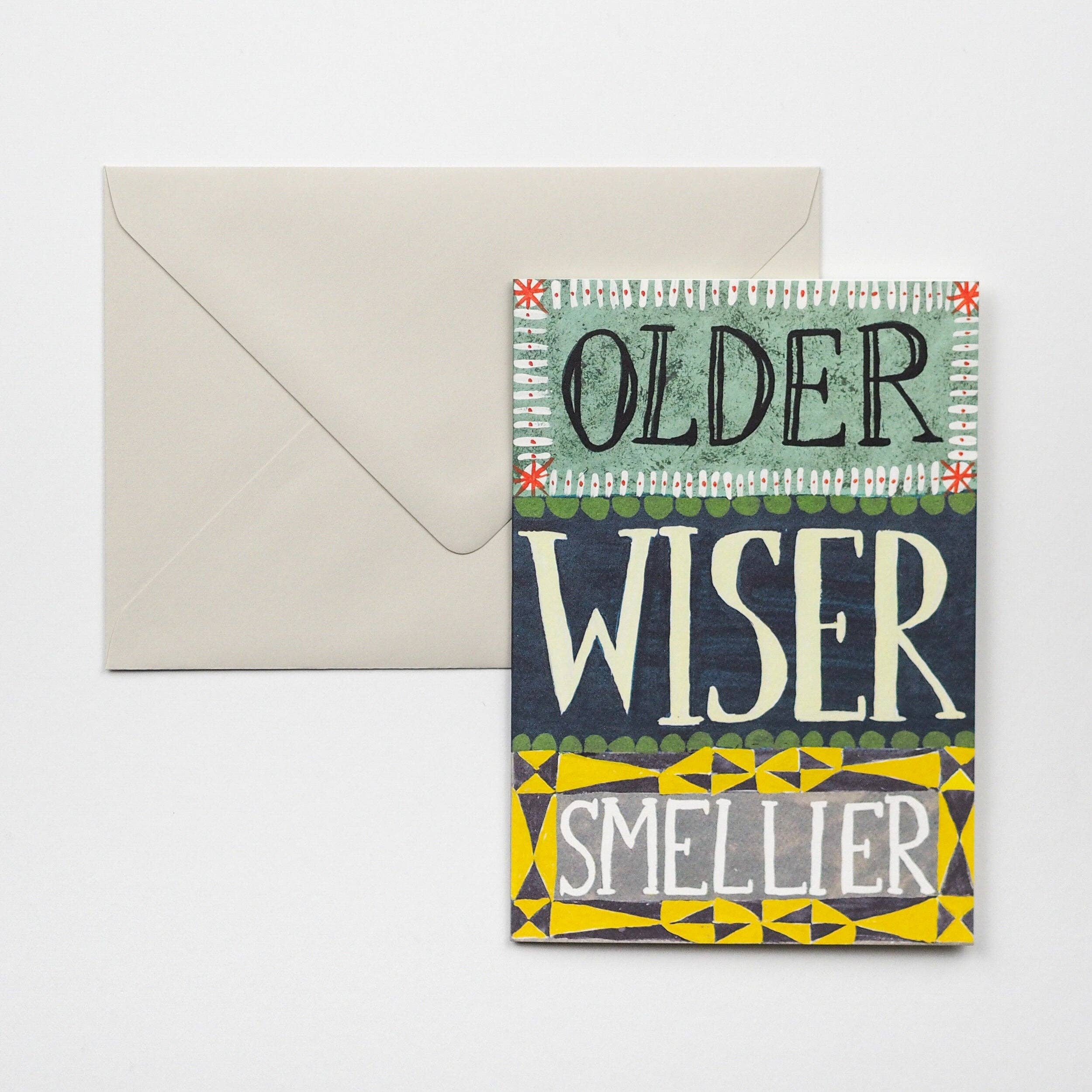 Greeting card with text 'Older, Wiser, Smellier' and envelope on a white background