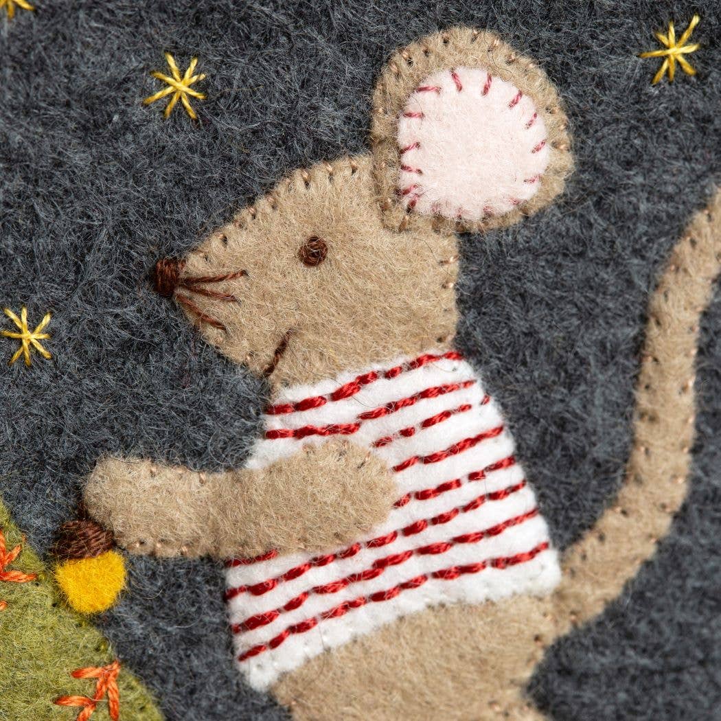 Felt mouse wearing a striped shirt with stars and flowers in the background