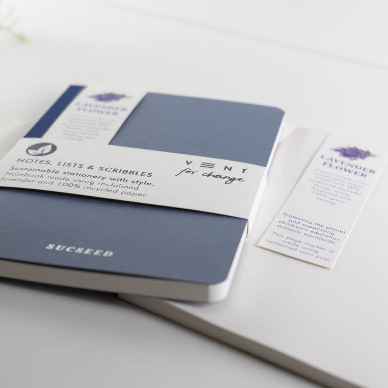 Blue notebook with white label on a light gray surface
