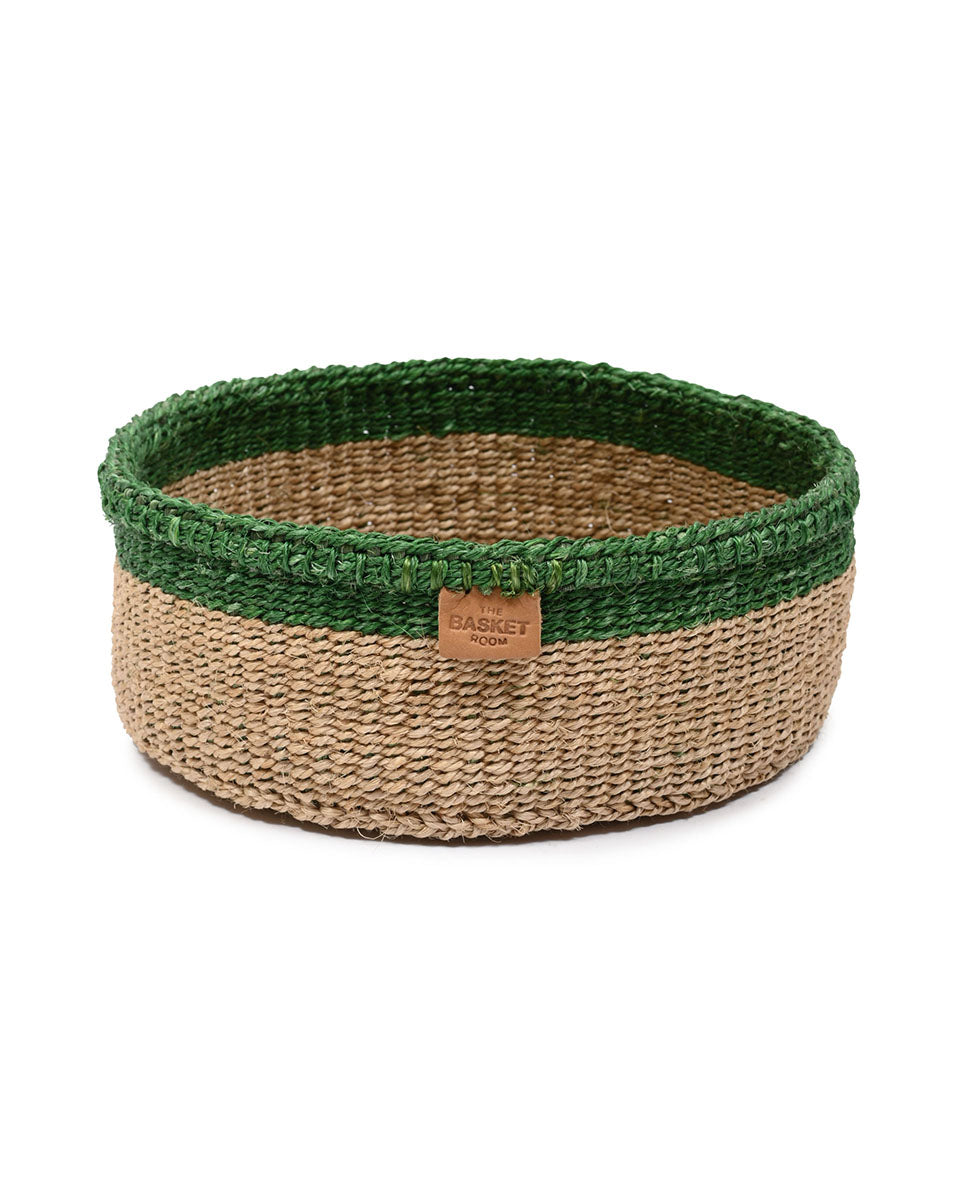 Woven basket with green top and natural bottom on a white background