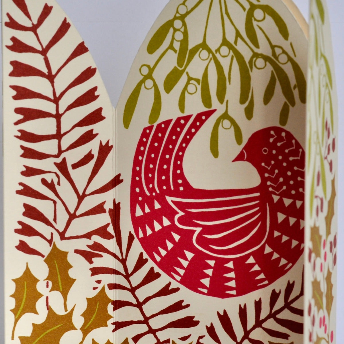 Decorative card with a red bird design and leaf patterns on a white background