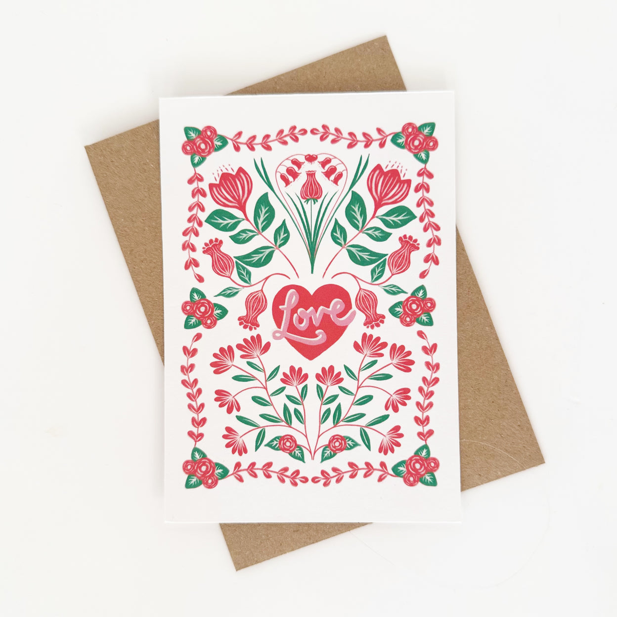 Greeting card with floral design and heart-shaped 'Love' on a white background