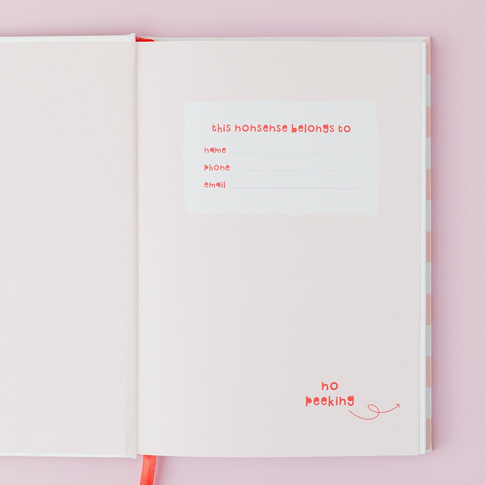 Open book with red text on a pink background