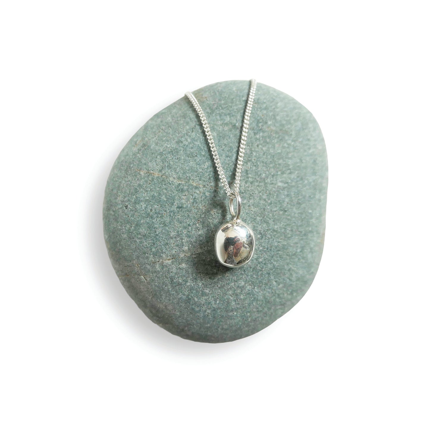 Silver necklace with a pendant on a green stone