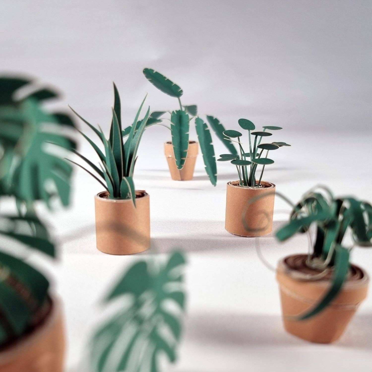 Small potted paper plants on a neutral background