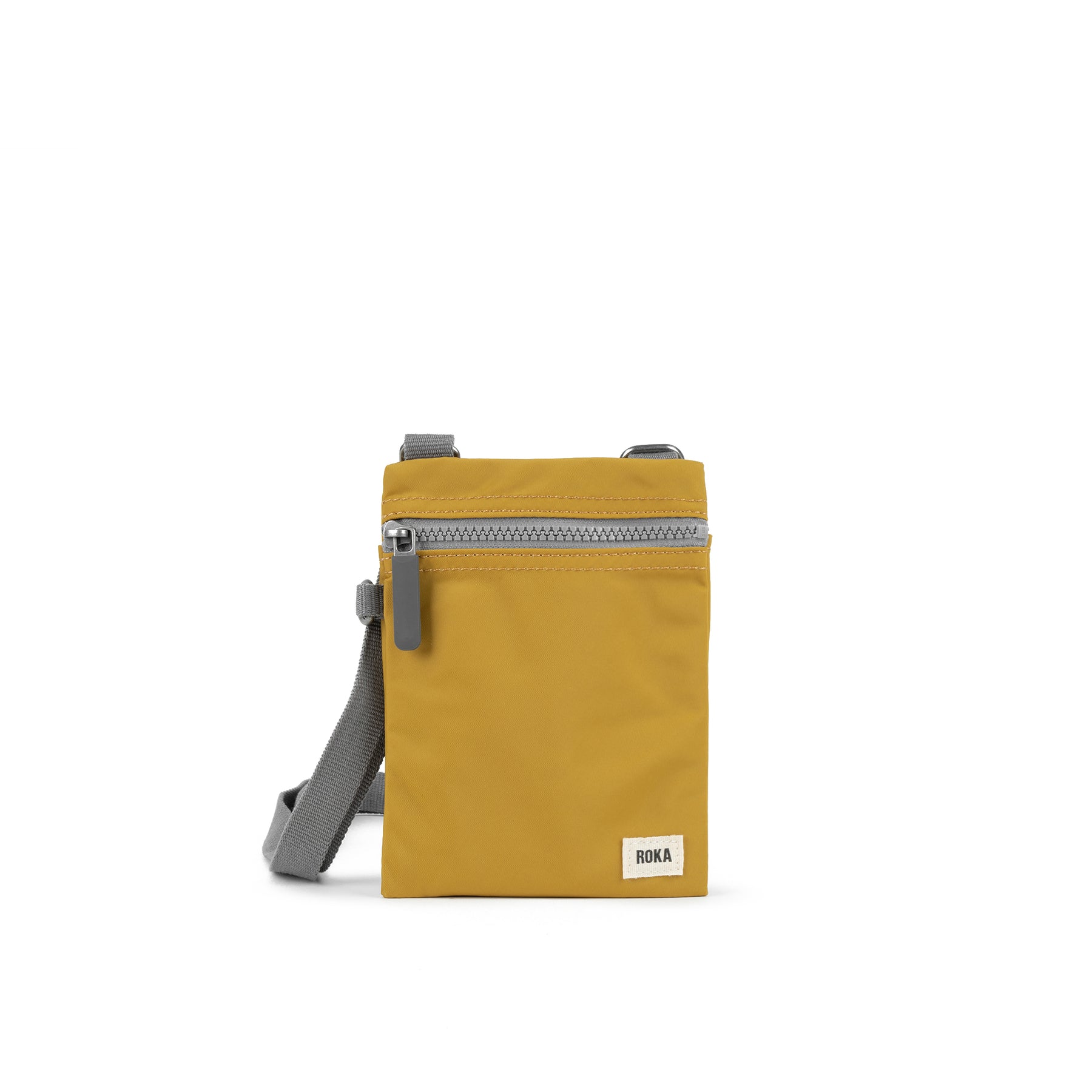 A yellow ROKA London Chelsea sling pocket bag with a smooth texture and a small front pocket, displayed against a white background.