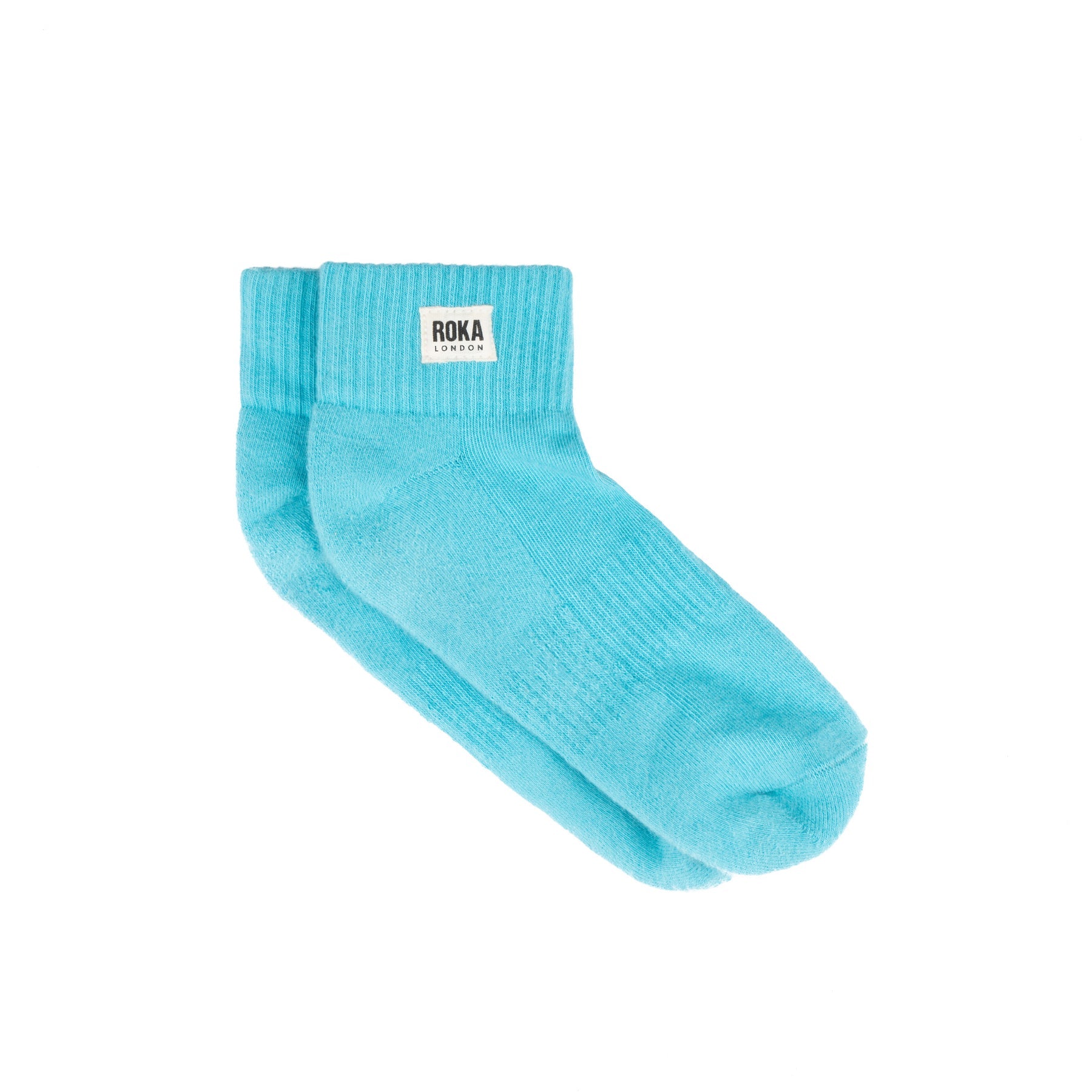 Turquoise sock with Roka branding on a white background