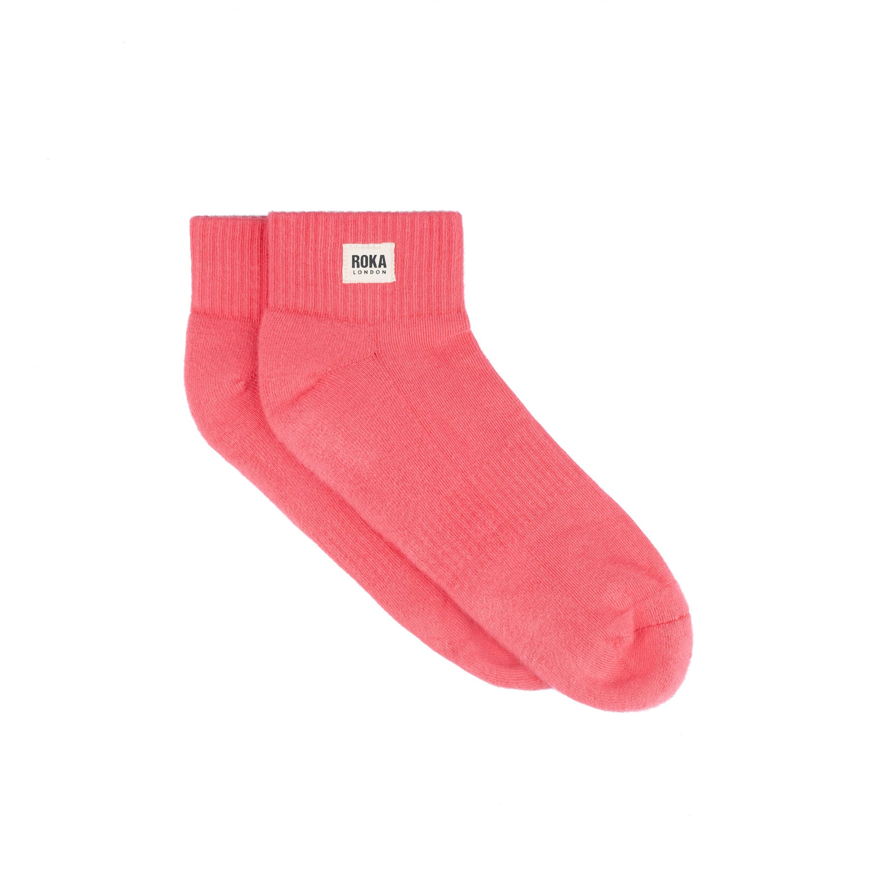 Pink sock with Roka label on a white background