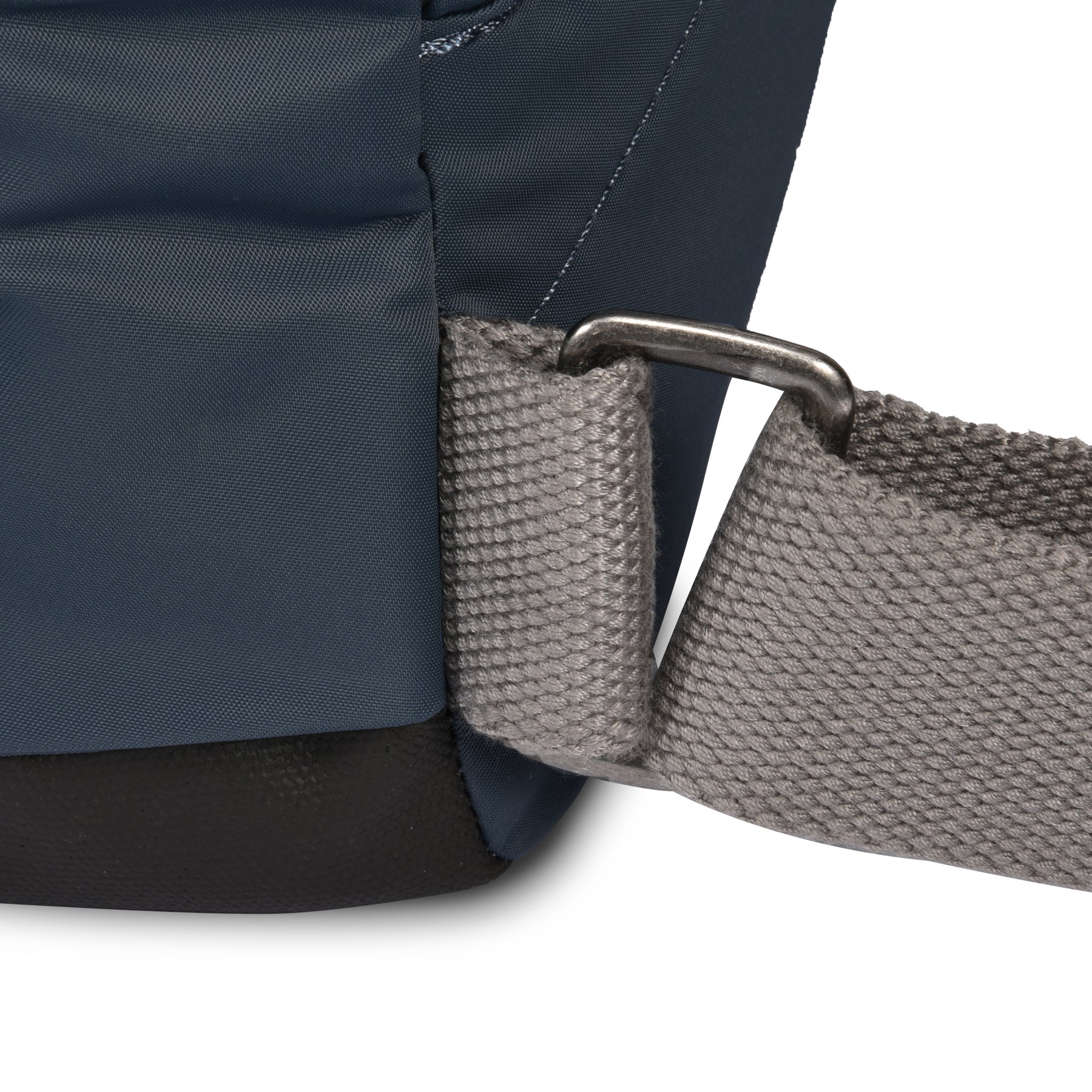 Close-up of a blue backpack with a gray strap on a white background