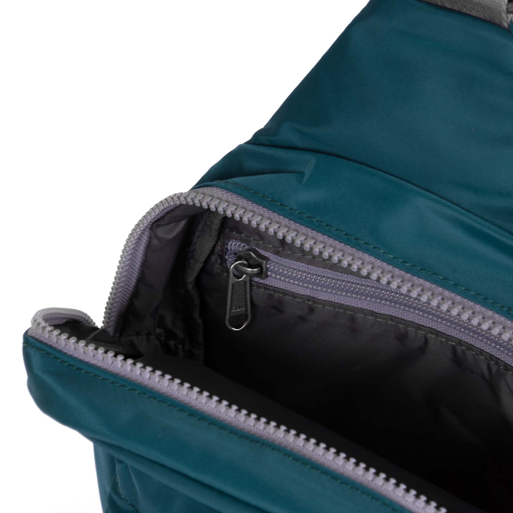 Close-up of a teal backpack with a zipper on a white background