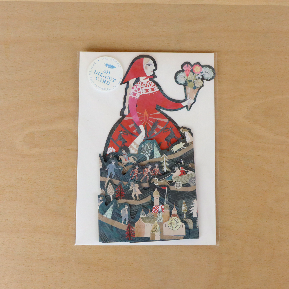 Greeting card with die-cut design on a wooden surface