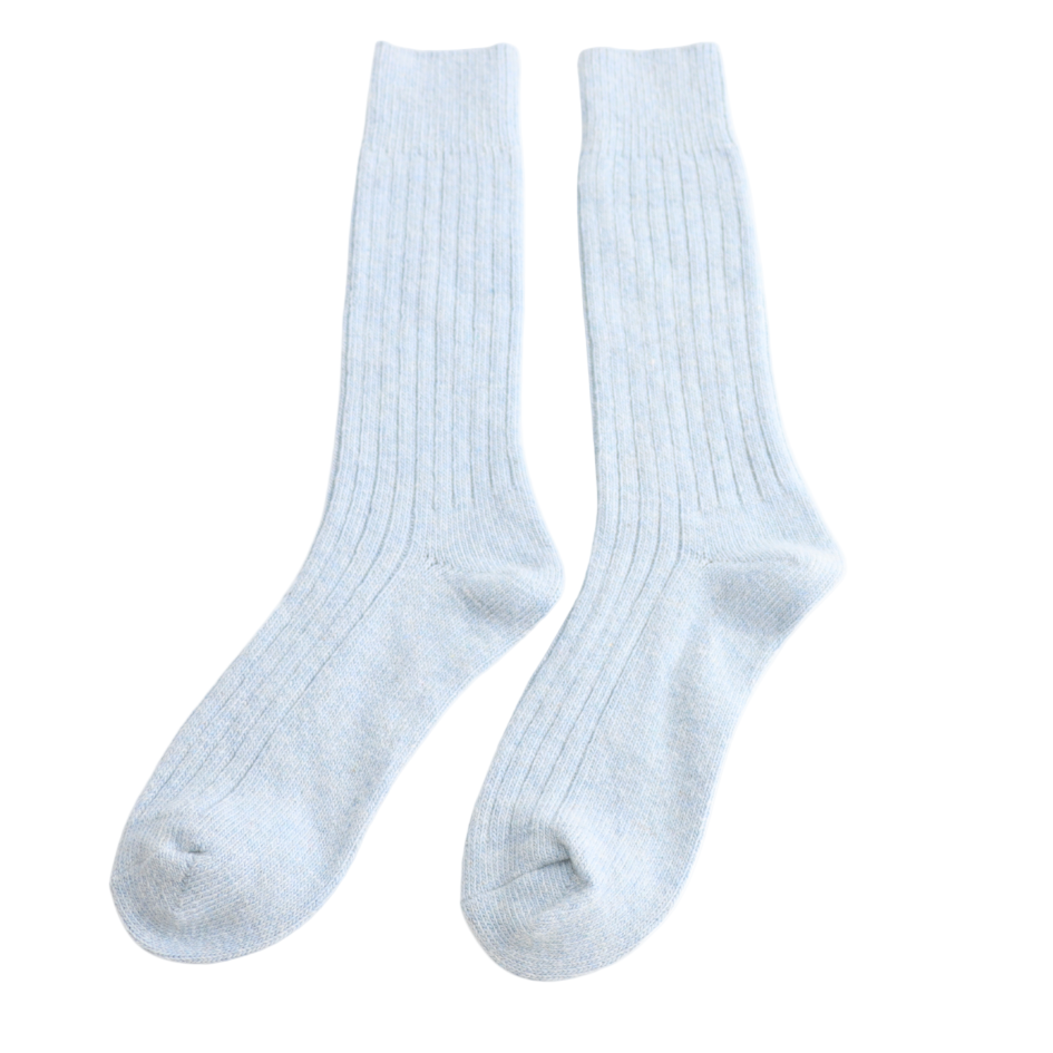 Pair of light blue socks on a white background