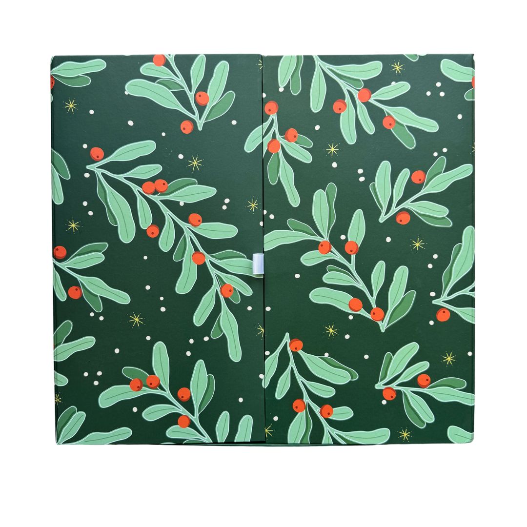 A green advent calendar with a Christmas-themed pattern of holly and berries, featuring gold and silver vermeil accents.