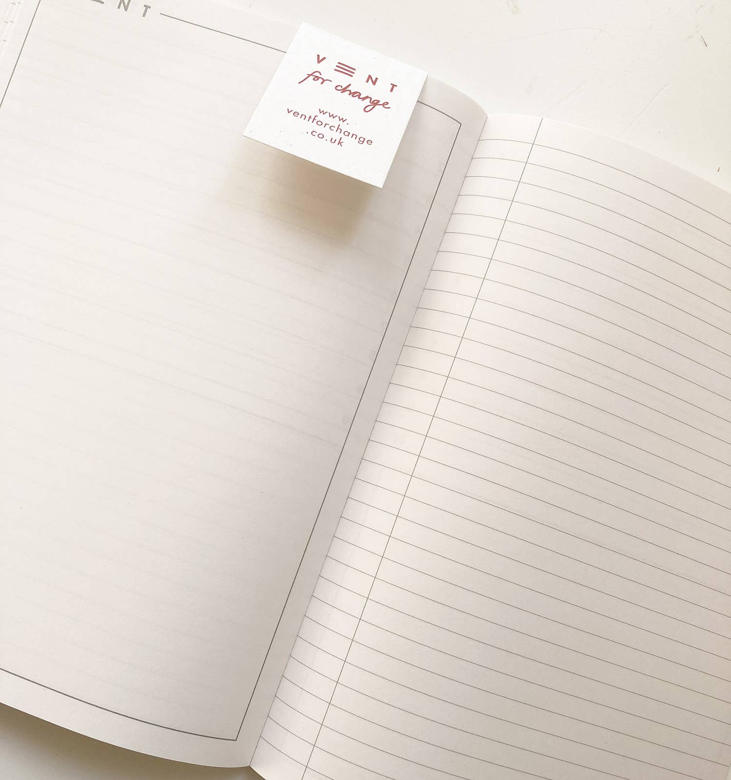 Open notebook with lined pages and a visible brand label on a white background