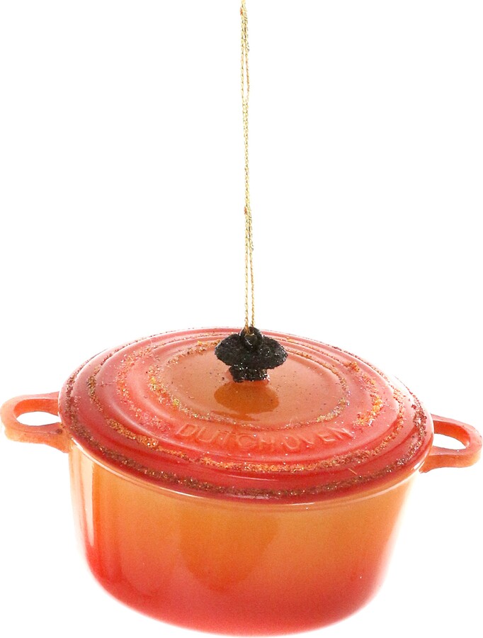 Red enameled cast iron pot with a lid on a white background