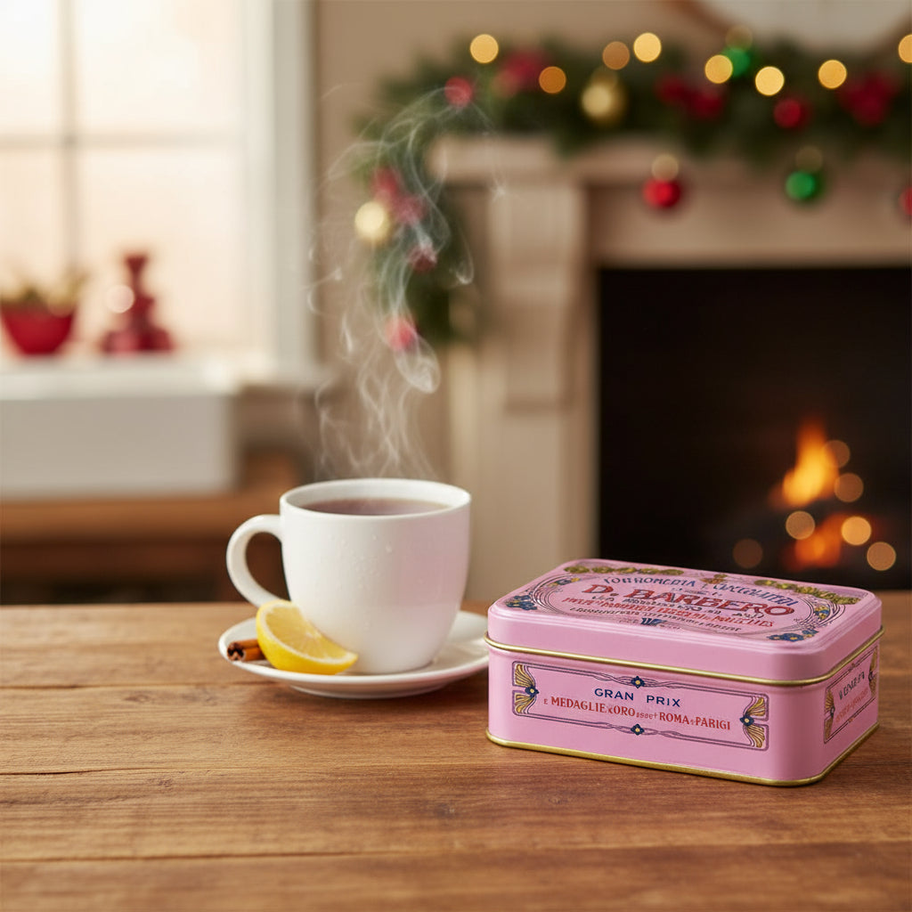 Pink vintage-style candy tin with decorative text and graphics on a white background