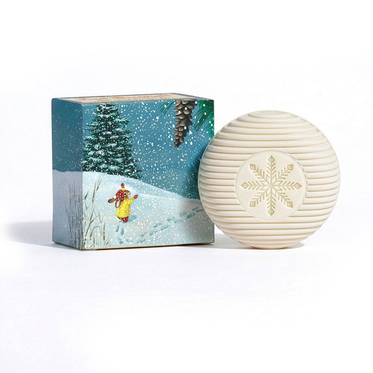 White textured ball with snowflake design next to a decorative box with winter scene