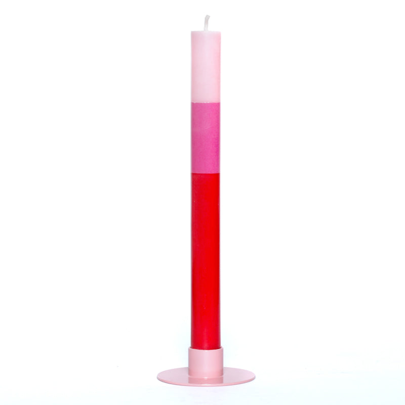 Two-toned pink and red candle on a white background