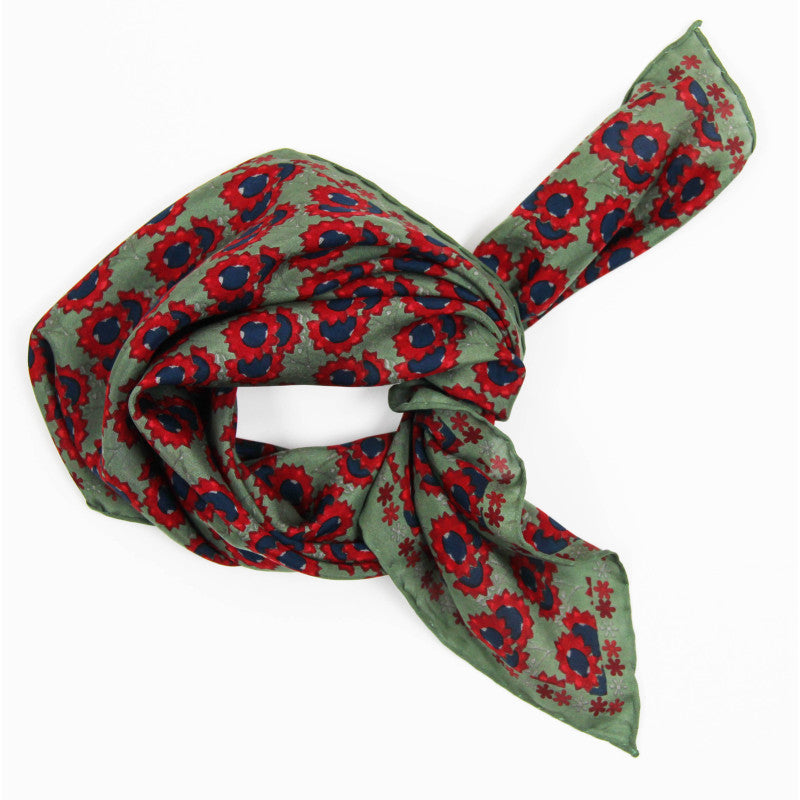 Green scarf with red and blue floral pattern on a white background