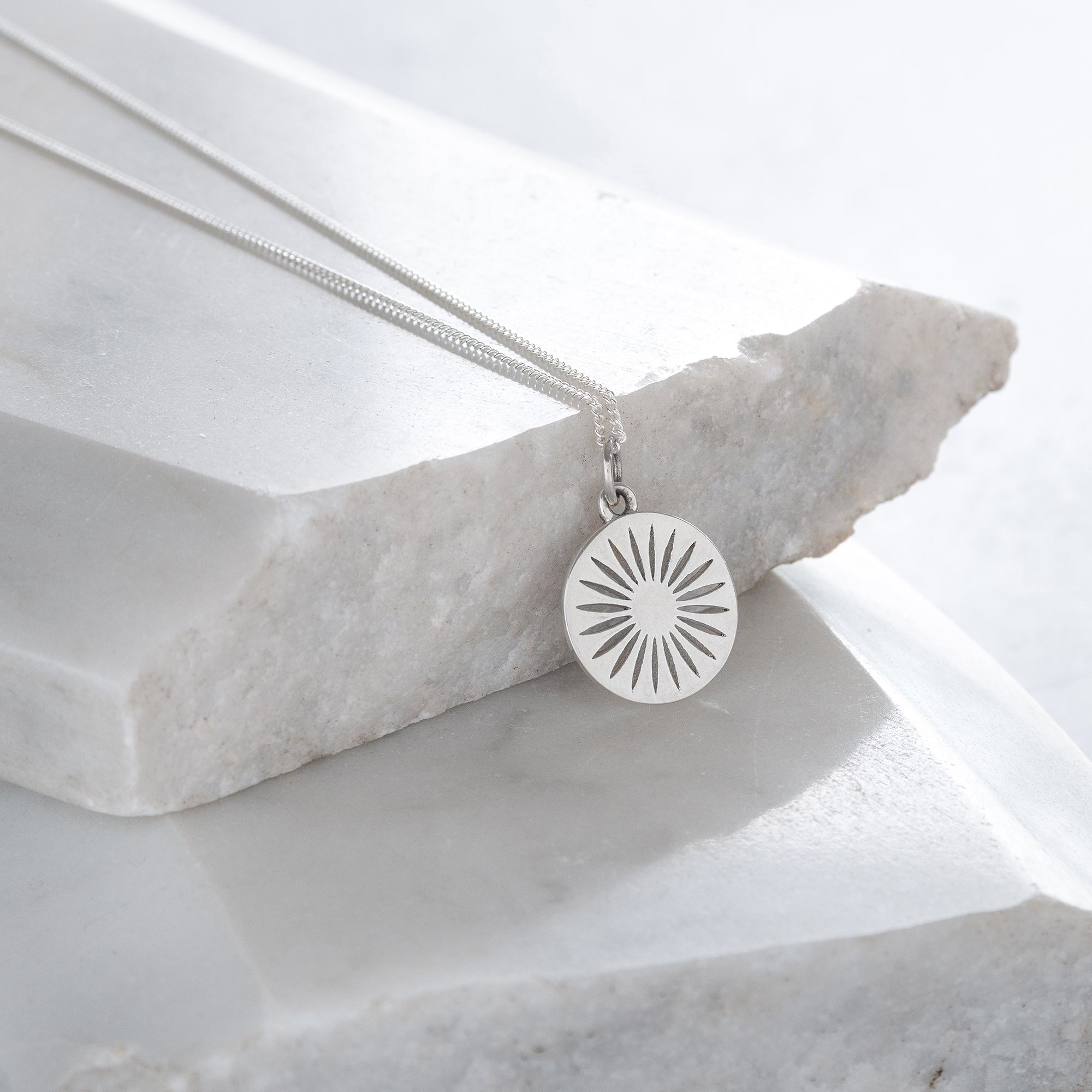 silver daisy on marble slab