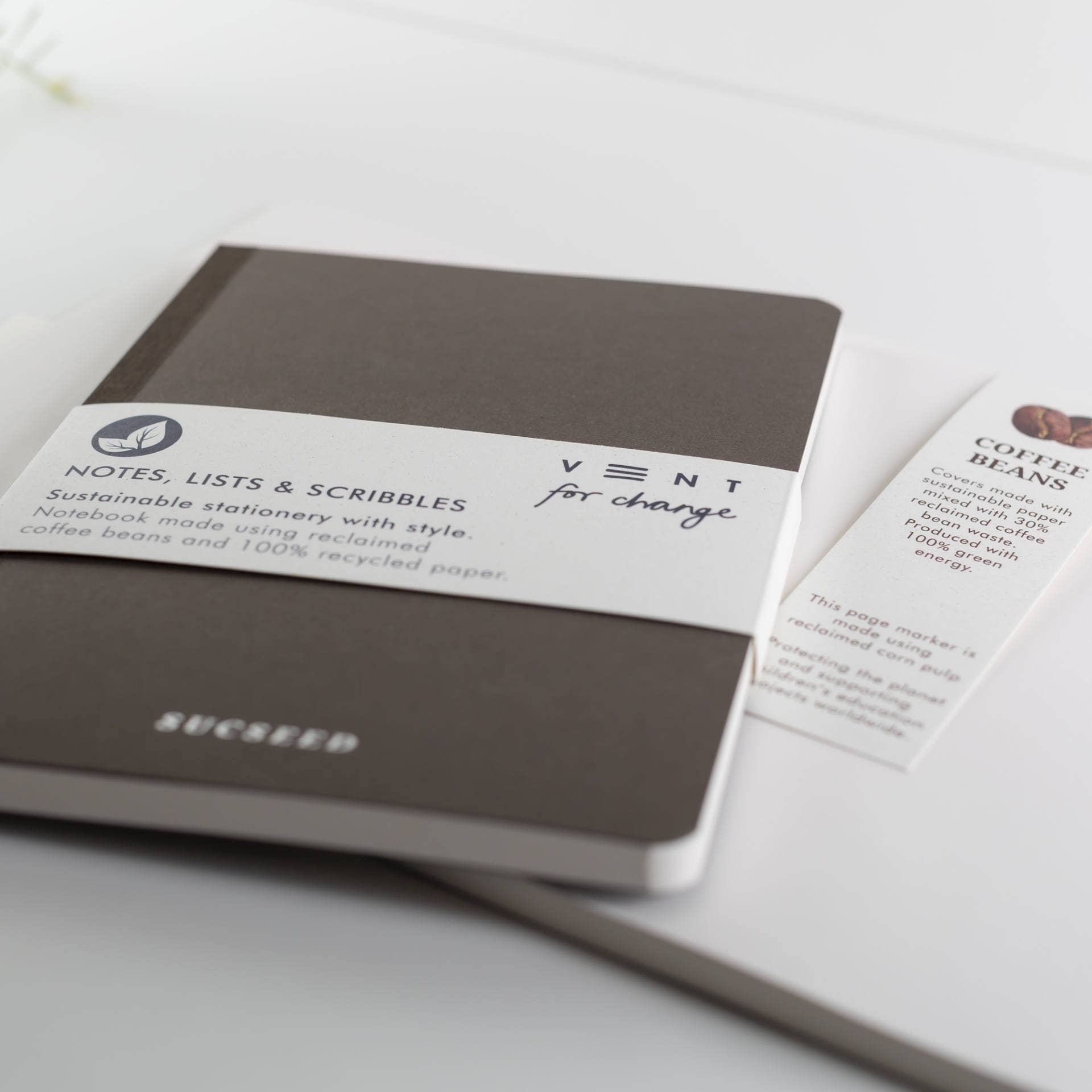 Brown notebook with a label on a white surface