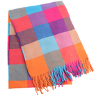 A folded woven throw blanket with a colorful plaid pattern and fringe tassels, shown on a plain white background.