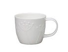 White ceramic mug with subtle design on a white background