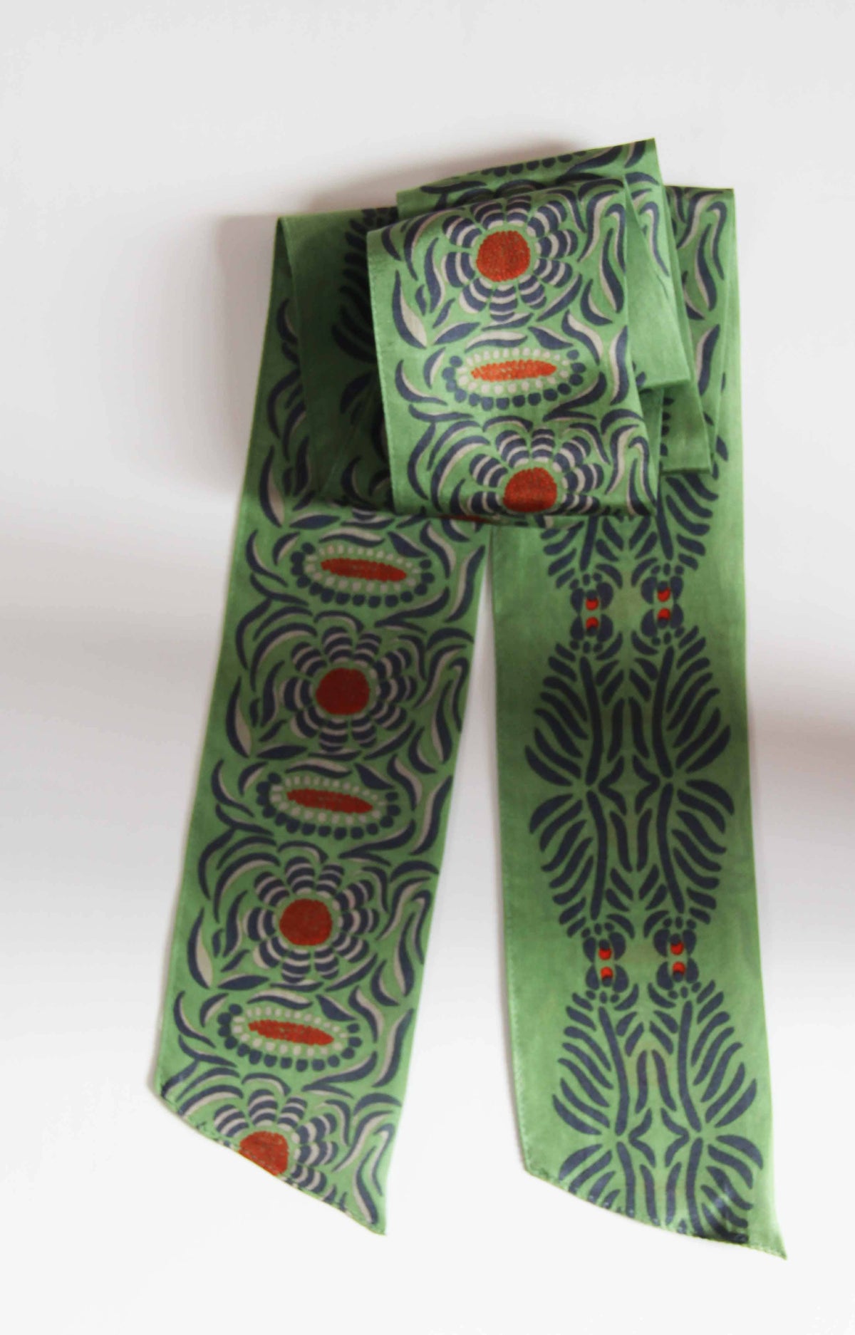 Green patterned scarf on a white background