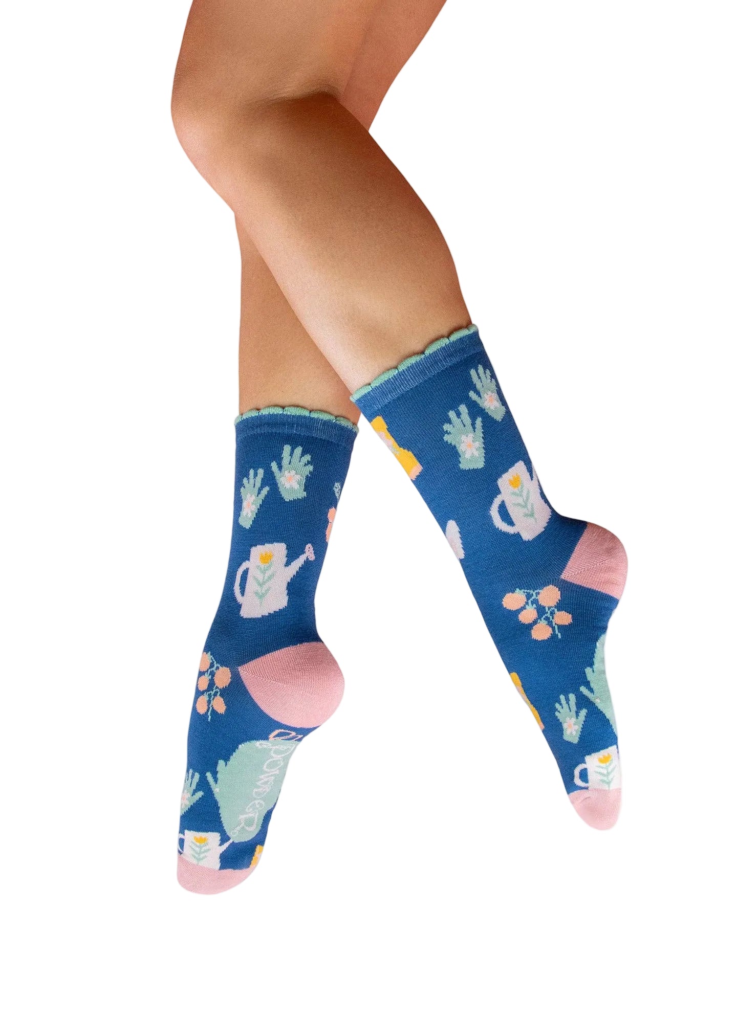 Blue socks with gardening-themed design worn by a person on a white background