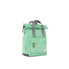 Angled view of a green backpack with gray straps on a white background