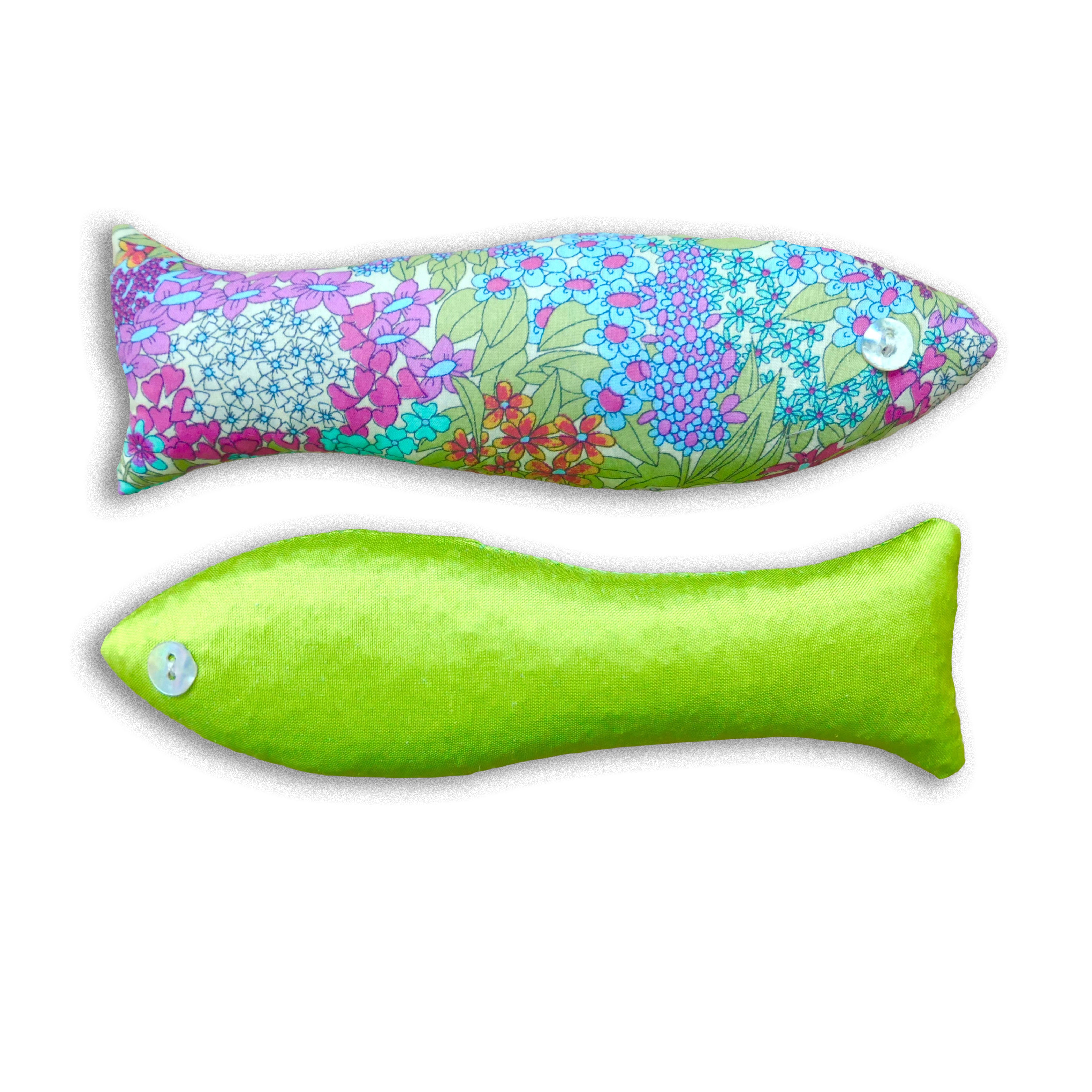 Two fish-shaped cotton and silk sachets, in lime green and pink floral fabric.