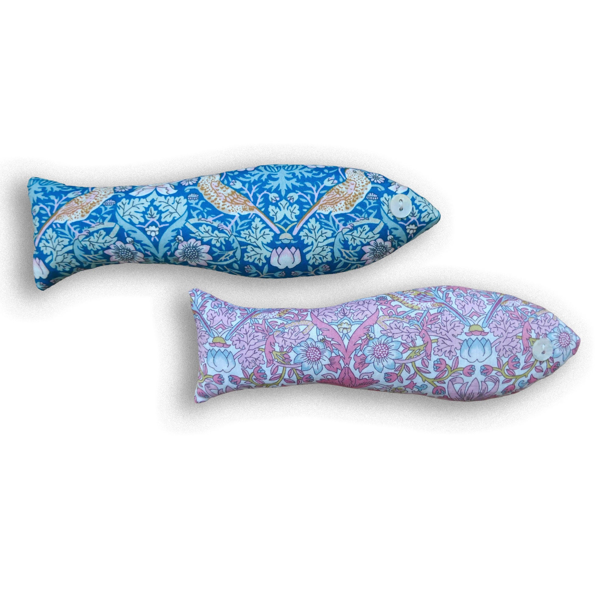 Two floral patterned fish-shaped sachets in pink and green on a white background