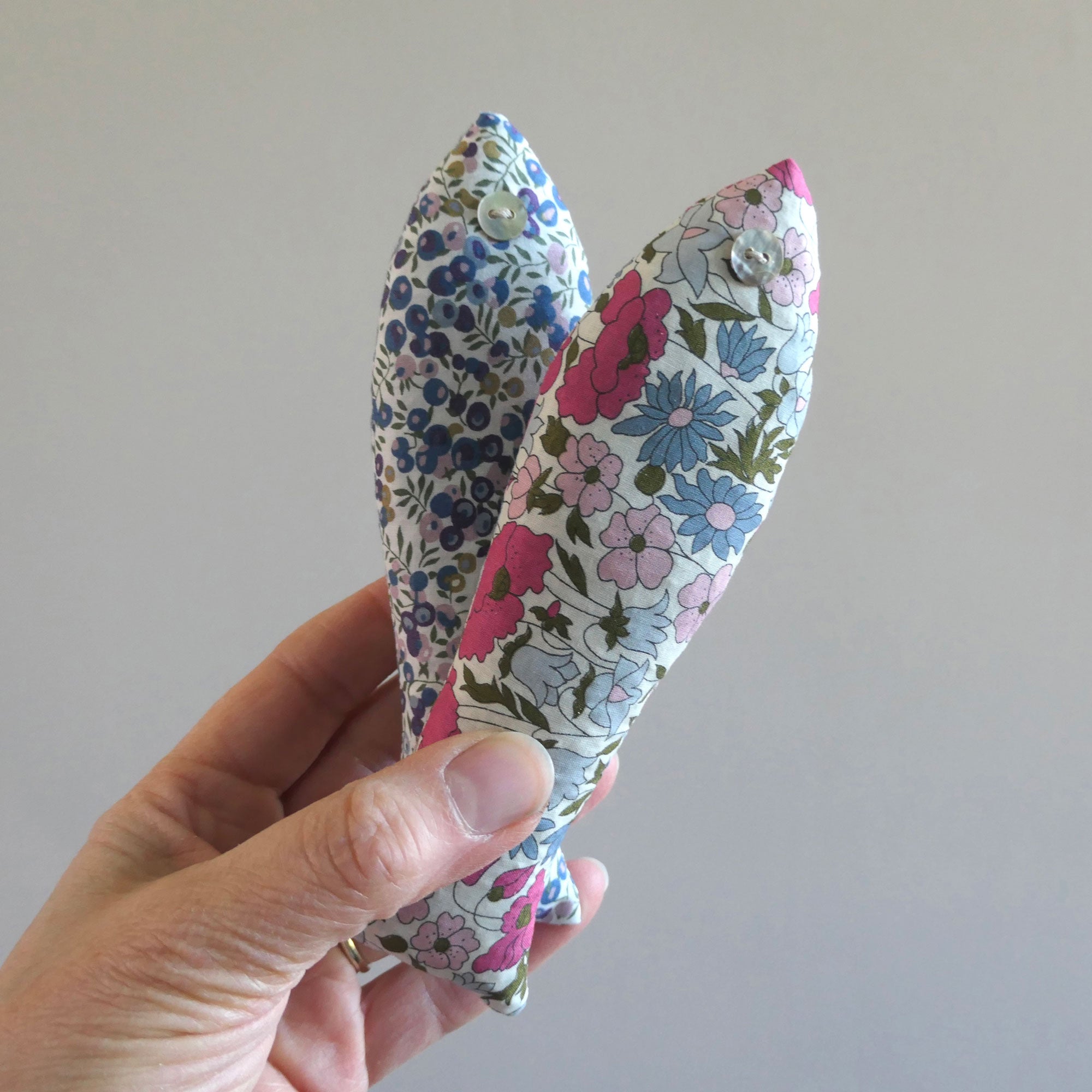 Two lafloral lavender fish held in a hand