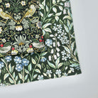 Floral and bird patterned fabric on a white background