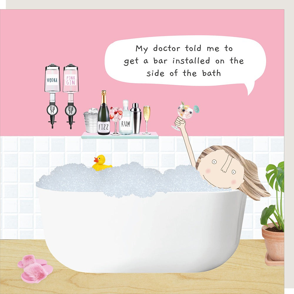 Greetings card showing a woman in a bathtub with drinks and a speech bubble, set against a pink wall.