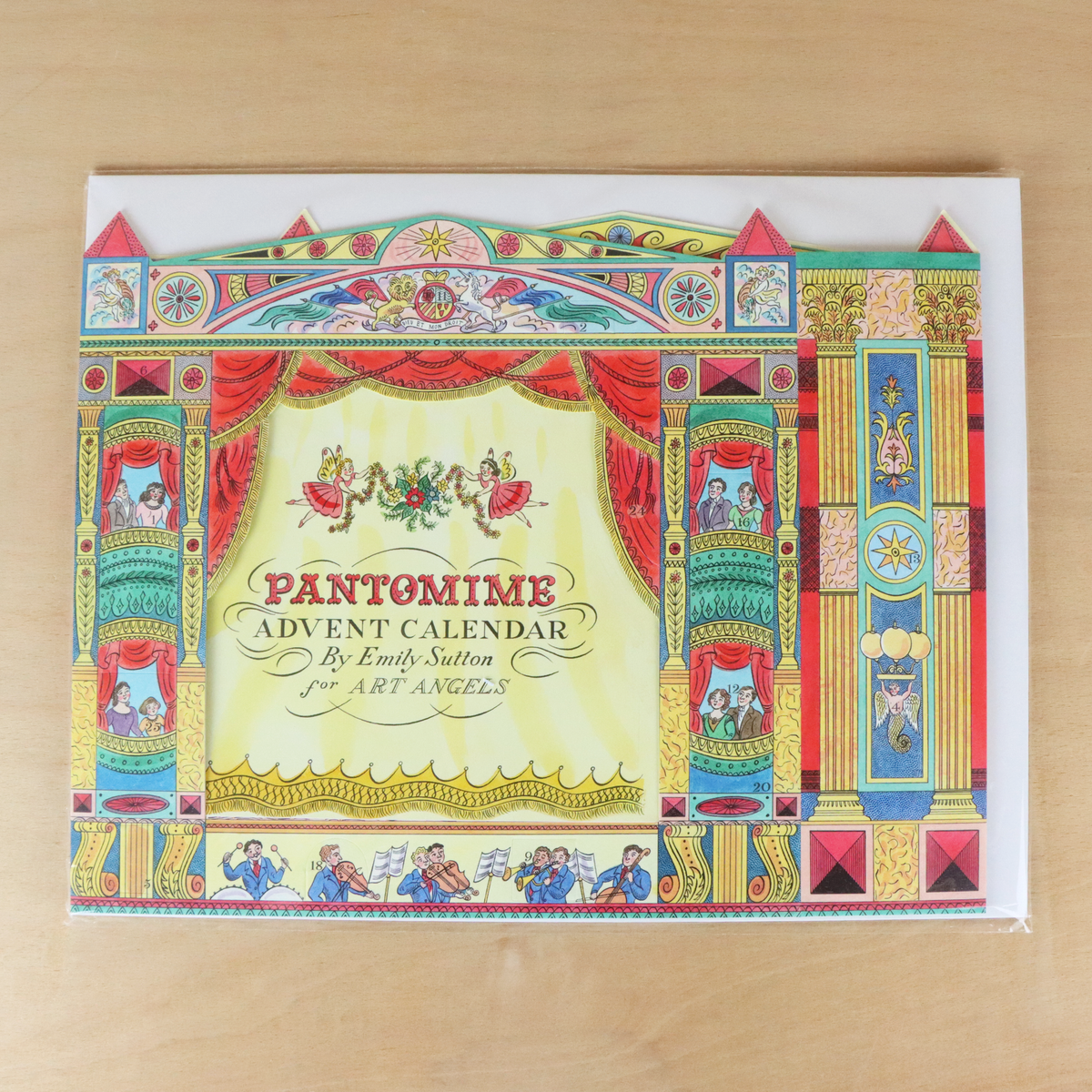 Pantomime Advent Calendar by Emily Sutton for Art Angels, featuring a highly detailed, colorful theatrical stage illustration on the front cover, set against a light wood background.
