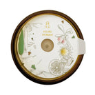 Round candle wax protector with floral designs and 'Fleurs d'Orient' text on a white background