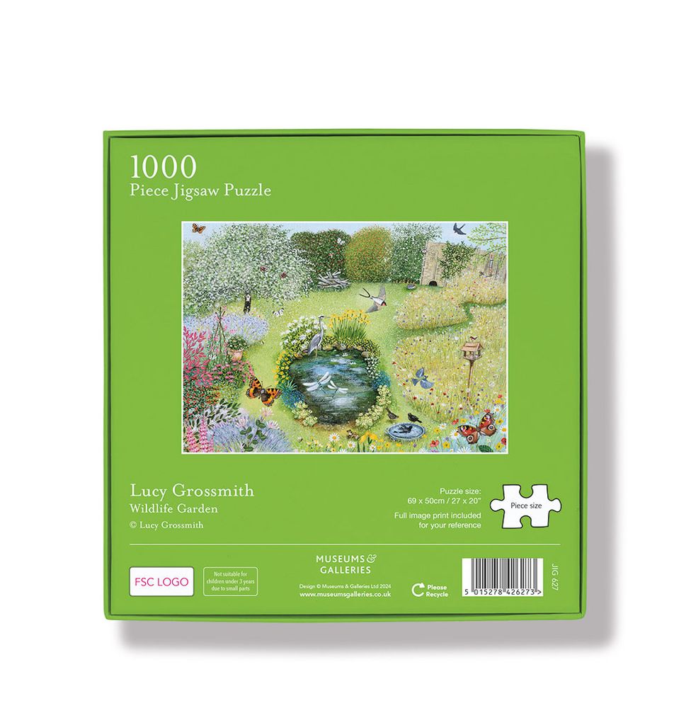 Jigsaw puzzle box with a garden scene on a green background