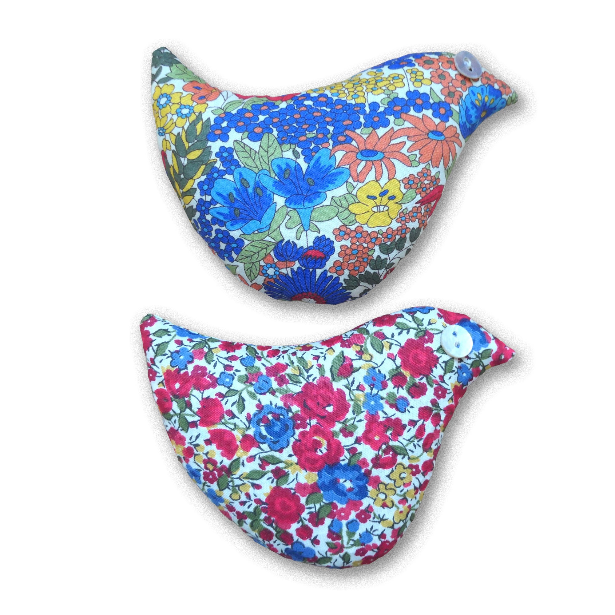 Two red and blue floral bird sachets on a white background