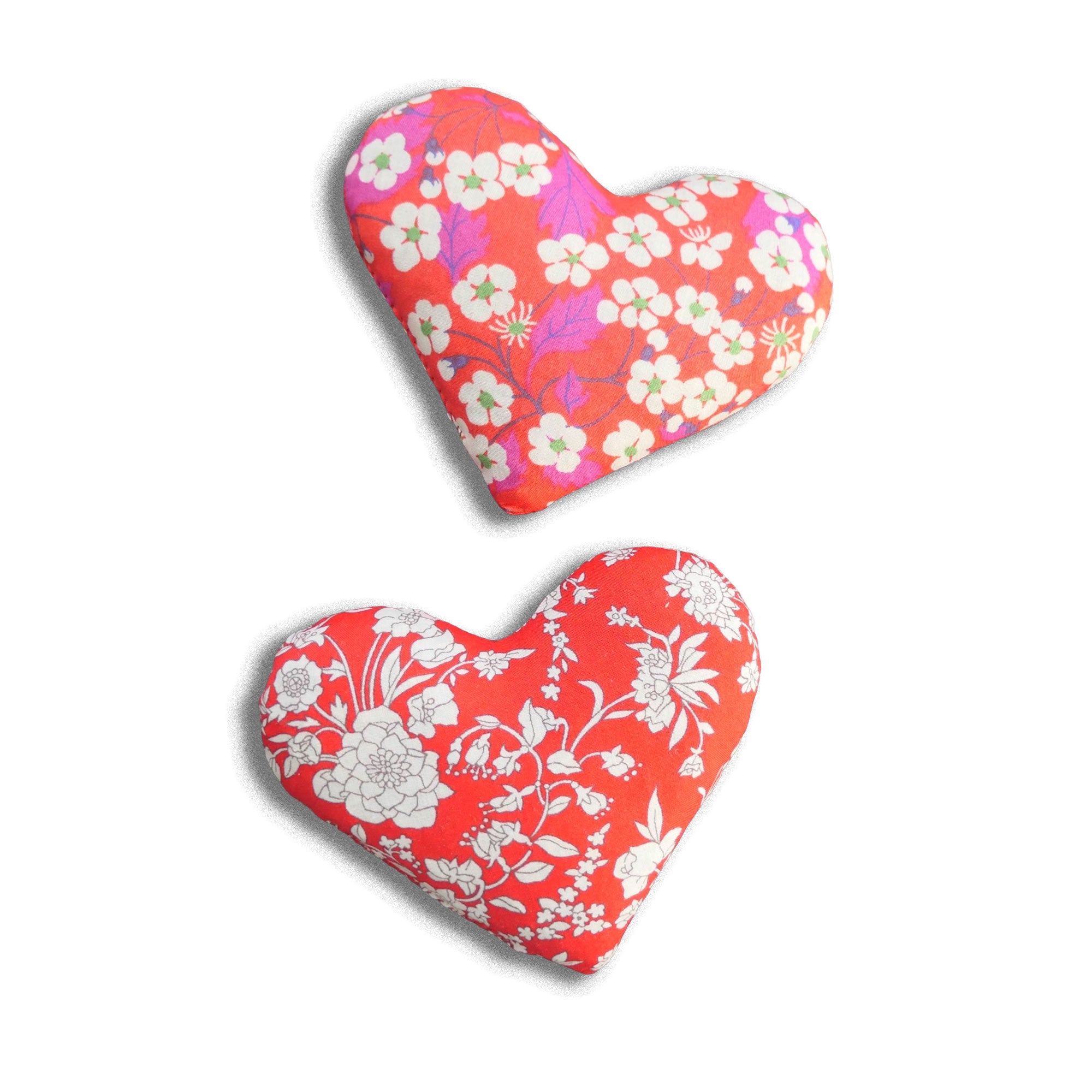 Two heart-shaped cotton lavender bags with floral patterns on a white background
