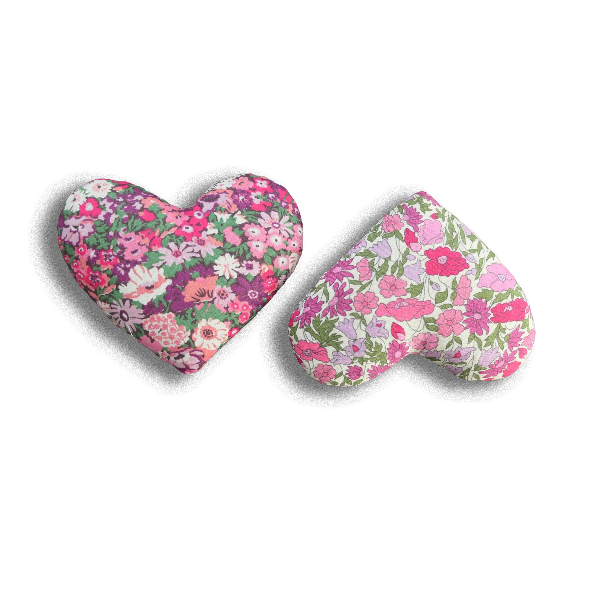 Two heart-shaped pink floral lavender pillows on a white background