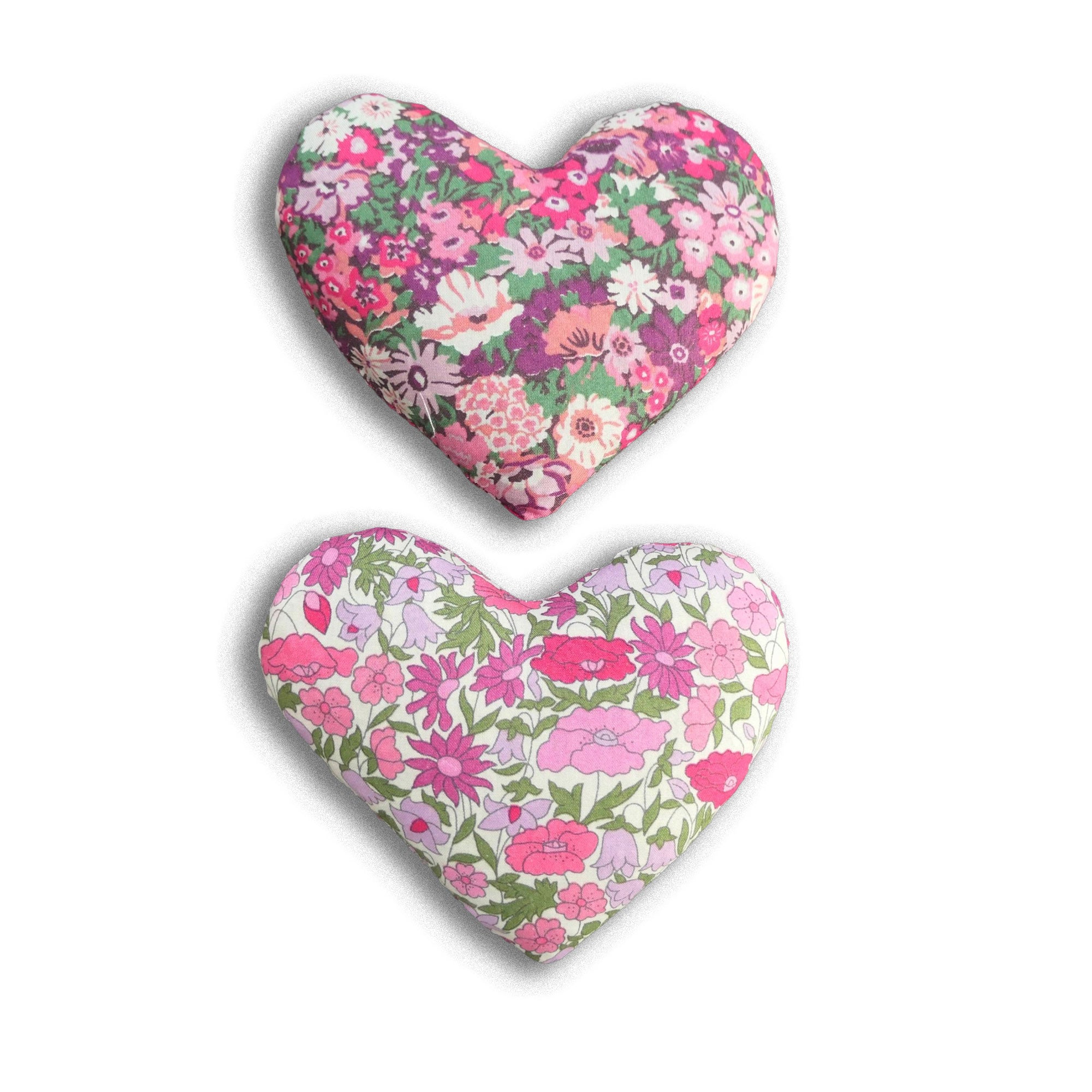 Two heart-shaped floral lavender sachets on a white background