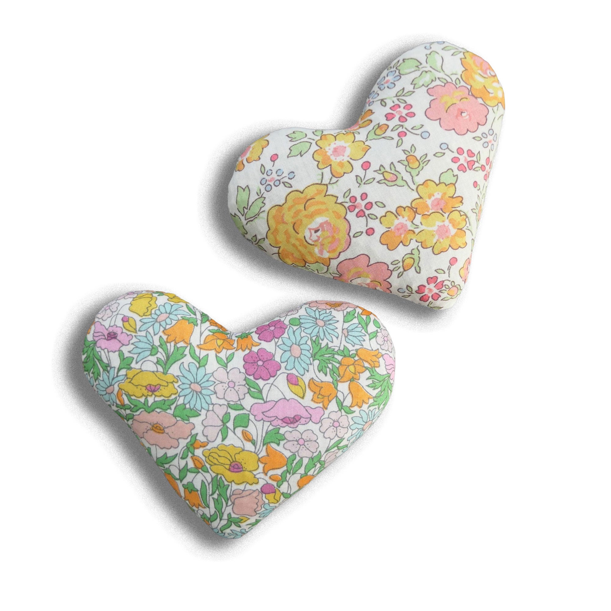 Two heart-shaped lavender sachets with orange and yellow floral patterns on a white background