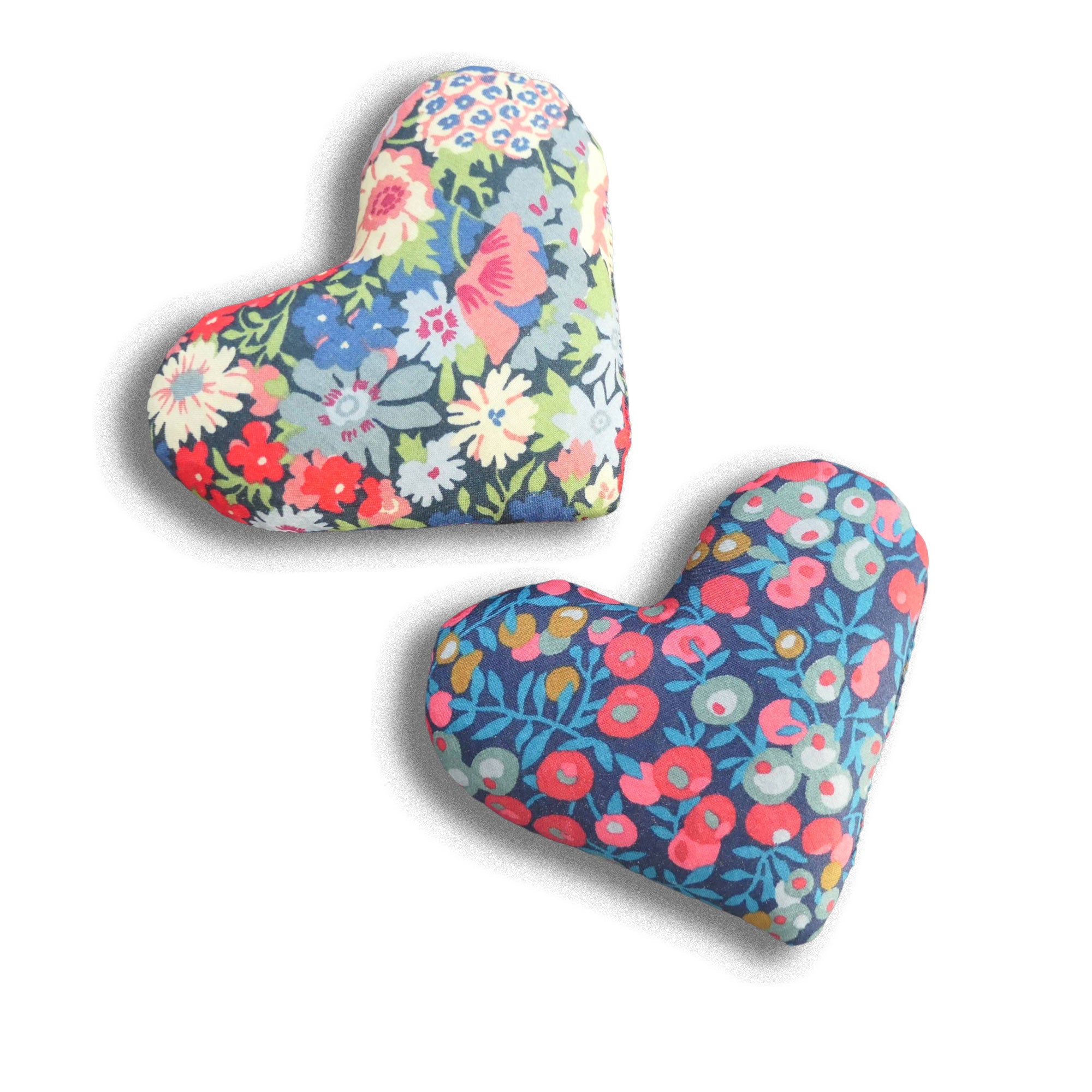 Two heart-shaped floral lavender bags on a white background
