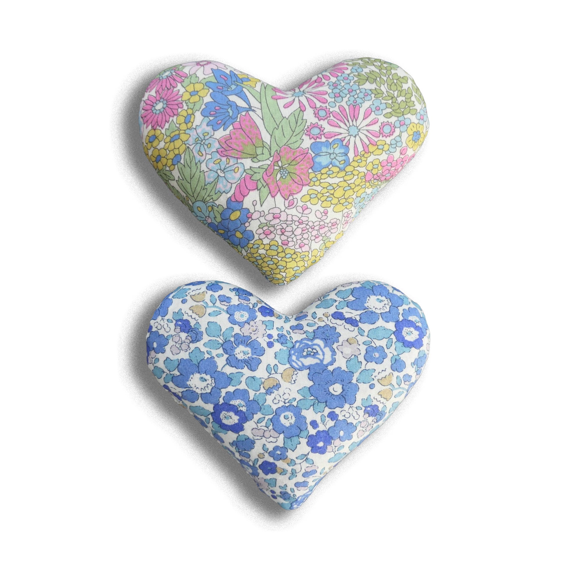 Two heart-shaped sachets with floral patterns on a white background