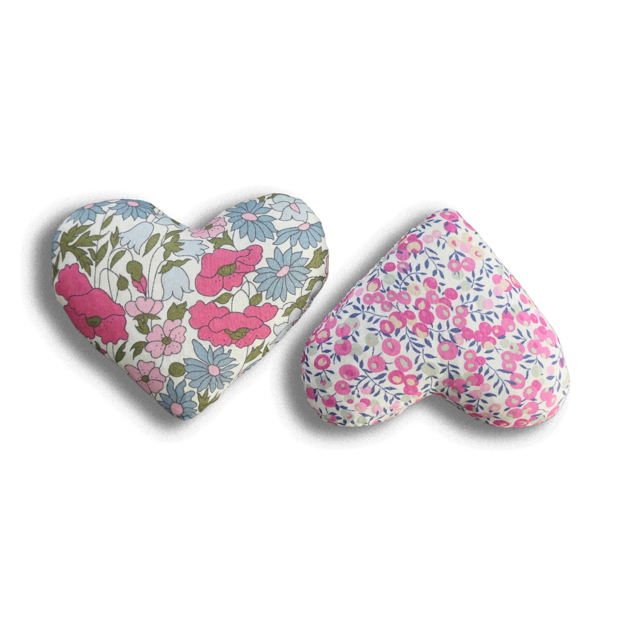 Two heart-shaped lavender bags with pink floral patterns on a white background
