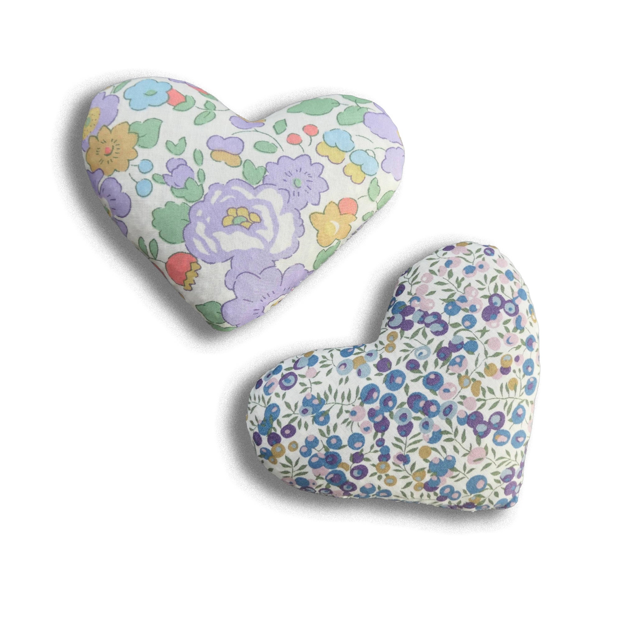 Floral-patterned heart-shaped sachets in purple on a white background