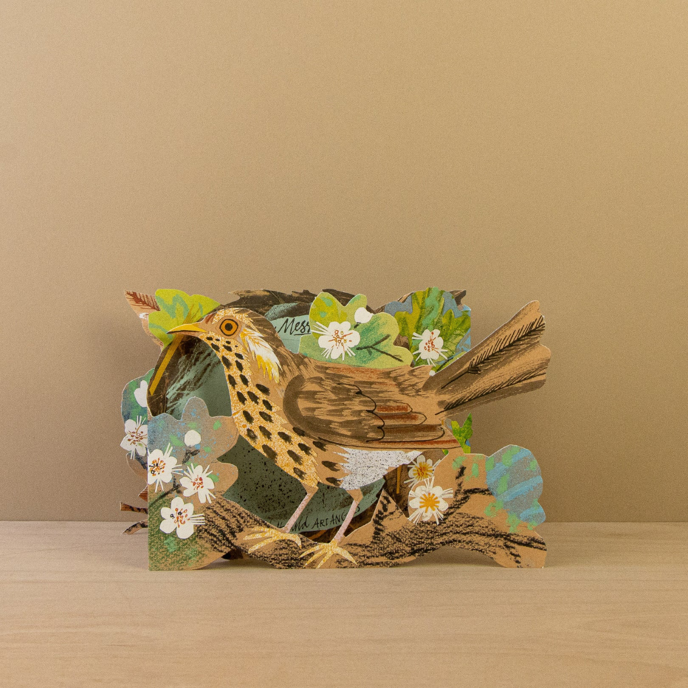 Card with a 3D bird design on a beige background